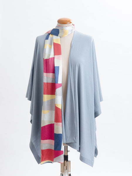 Mod Colour Block scarf, a geometric layering of muted bright hues, this scarf goes with almost anything! Soft blocks of blue, blush, cerise, garnet rust, sage, yellow, grey and pale blue melded together to take versatility to a whole new level. Self-lined in a tubular shape so it stays put hanging, or ties easily, never loosing shape and looking great no matter how you wear it.  100% silk satin Luxury, paired here with a powder blue muse wrap.