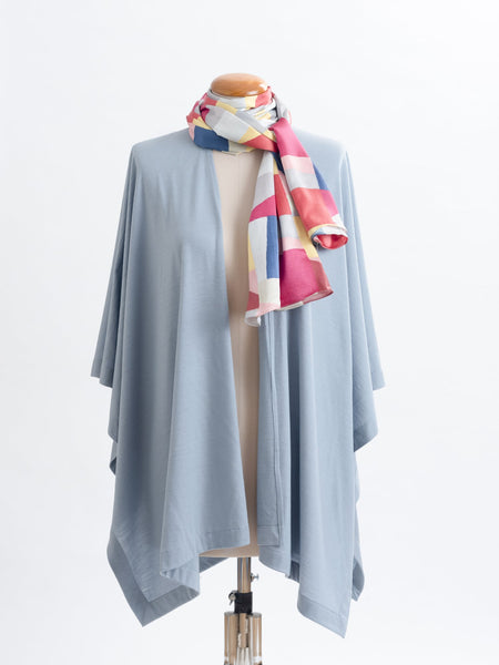 Mod Colour Block scarf, a geometric layering of muted bright hues, this scarf goes with almost anything! Soft blocks of blue, blush, cerise, garnet rust, sage, yellow, grey and pale blue melded together to take versatility to a whole new level. Self-lined in a tubular shape so it stays put hanging, or ties easily, never loosing shape and looking great no matter how you wear it.  100% silk satin Luxury, paired here with a powder blue muse wrap.