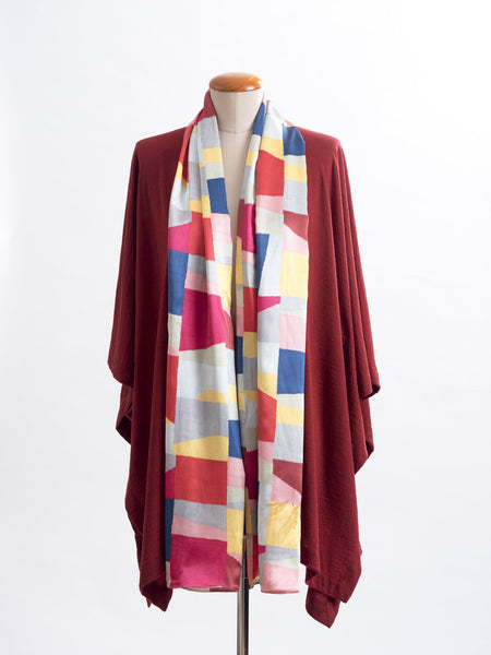 Mod Colour Block scarf, a geometric layering of muted bright hues, this scarf goes with almost anything! Soft blocks of blue, blush, cerise, garnet rust, sage, yellow, grey and pale blue melded together to take versatility to a whole new level. Self-lined in a tubular shape so it stays put hanging, or ties easily, never loosing shape and looking great no matter how you wear it.  100% silk satin Luxury, paired here with a garnet rust Muse wrap.