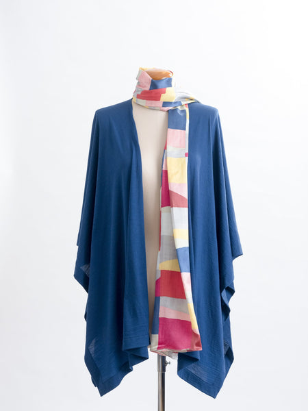 Mod Colour Block scarf, a geometric layering of muted bright hues, this scarf goes with almost anything! Soft blocks of blue, blush, cerise, garnet rust, sage, yellow, grey and pale blue melded together to take versatility to a whole new level. Self-lined in a tubular shape so it stays put hanging, or ties easily, never loosing shape and looking great no matter how you wear it.  100% silk satin Luxury, paired here with a teal muse wrap.