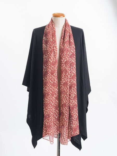 Odette Floral Silk Scarf  Sheer, soft and feminine, this floral silk has a beautiful fine pleat like creped texture, garnet rust flowers and leaves layered on a wash of cream and blush, with soft white highlights. An amazing accessory to pair with so many colours and a perfect way to add some warmth up near your face if you’re wearing a white T and jeans.  !00% Silk Yoryu pictured here with the black Muse Merino wrap.