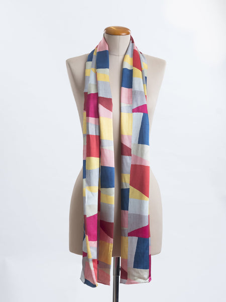 A geometric layering of muted bright hues, this scarf goes with almost anything! Soft blocks of blue, blush, cerise, garnet rust, sage, yellow, grey and pale blue melded together to take versatility to a whole new level. Self-lined in a tubular shape so it stays put hanging, or ties easily, never loosing shape and looking great no matter how you wear it.  100% silk satin Luxury