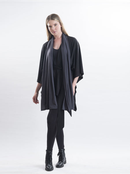 Elle in charcoal Merino wool, layered over the belted Muse wrap.