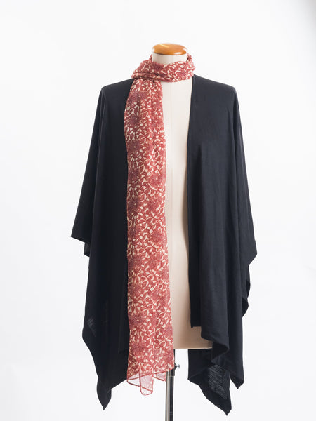 Odette Floral Silk Scarf  Sheer, soft and feminine, this floral silk has a beautiful fine pleat like creped texture, garnet rust flowers and leaves layered on a wash of cream and blush, with soft white highlights. An amazing accessory to pair with so many colours and a perfect way to add some warmth up near your face if you’re wearing a white T and jeans.  !00% Silk Yoryu pictured here with the black Muse Merino wrap.